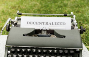 Paper attached to typewriter reading Decentralized