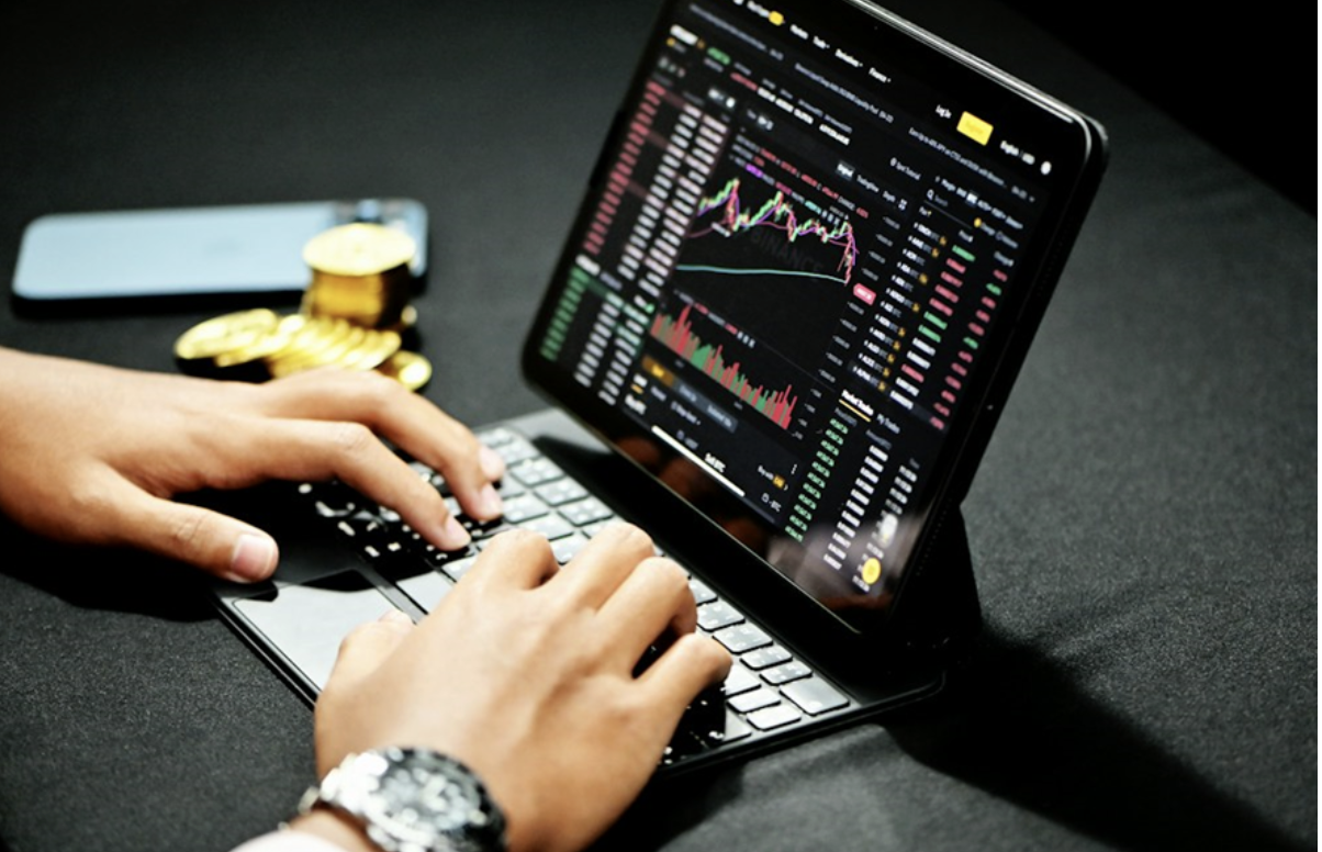 man trading digital assets using a laptop